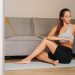 Woman practicing yoga indoors on a mat, embodying fitness and tranquility.